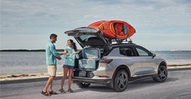 A couple at the beach with their Equinox EV