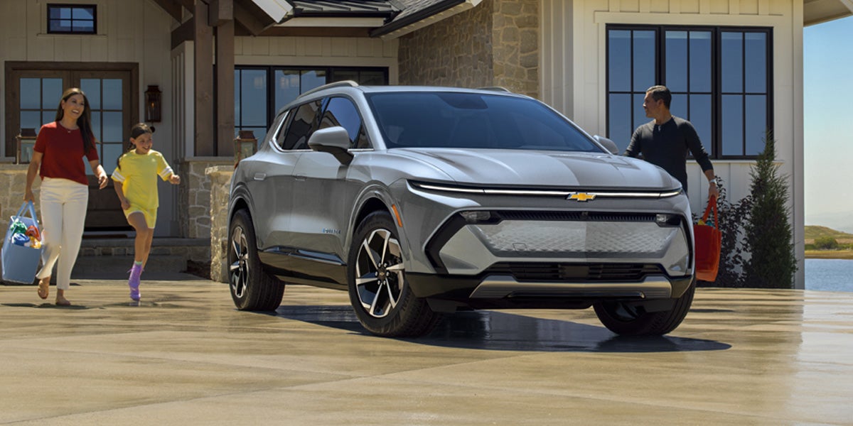A family getting into s silver Equinox EV